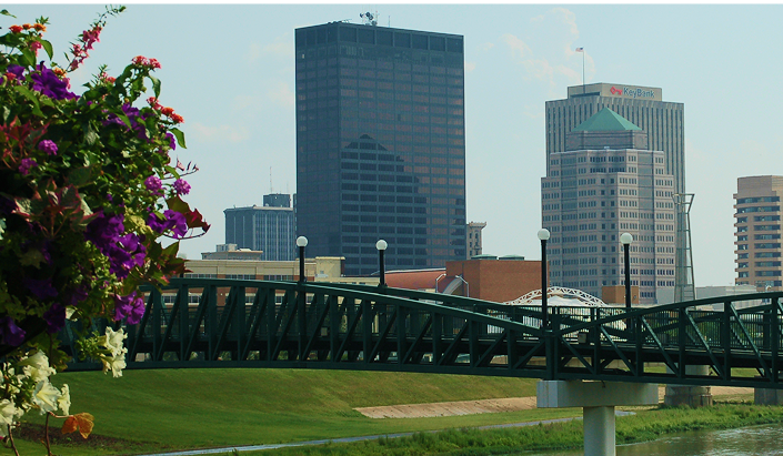 Downtown Dayton investment exceeding $600 million, featuring Fifth Third Field, RiverScape MetroPark, Schuster Center, and CareSource headquarters, with new construction and historic building renovations.